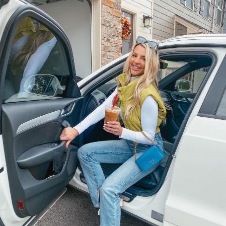 Ryleigh Vertes is in her car with a latte in her hand.